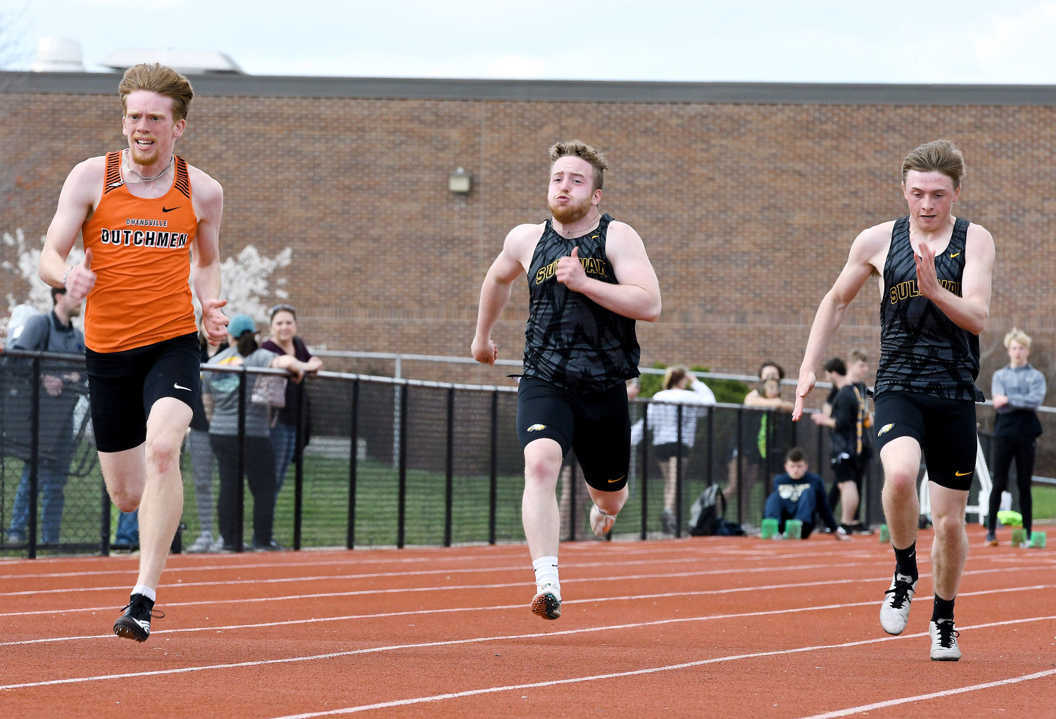 Charlie Whelan (far left) sprints ahead of a pair of Sullivan Eagles during one of several heats of the boys 100-meter dash in last Tuesday’s home track meet at Dutchmen Field. Due to Good Friday, the annual OHS Relays will be held tomorrow (Thursday) and return to its traditional Friday slot next year.